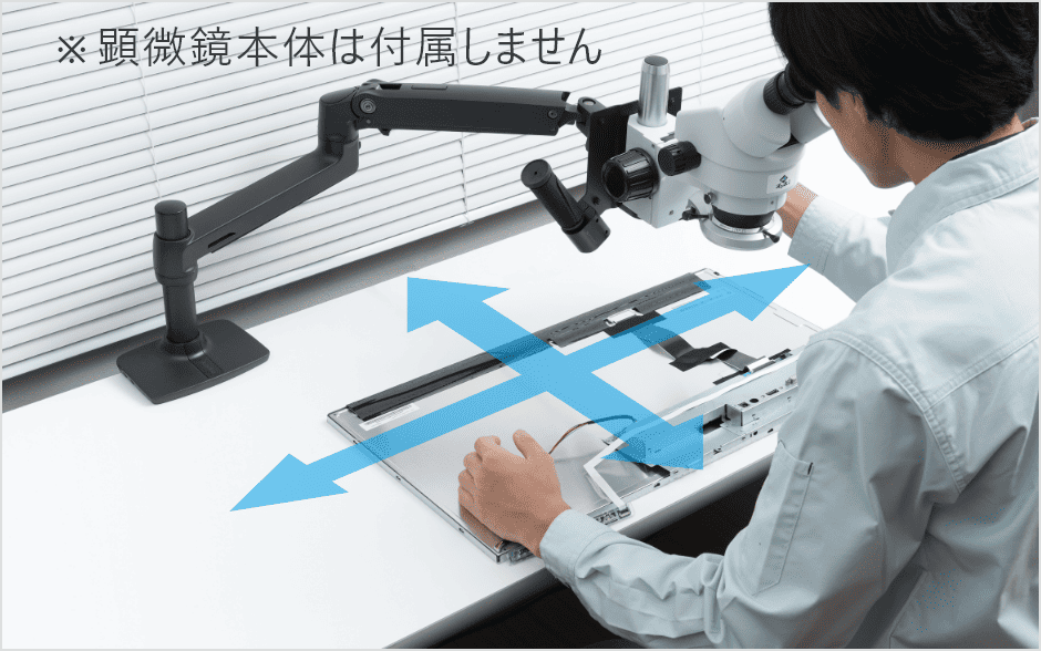 Researcher adjusts a microscope setup with a robotic arm; blue arrows show X/Y movement directions (note: microscope body not included).